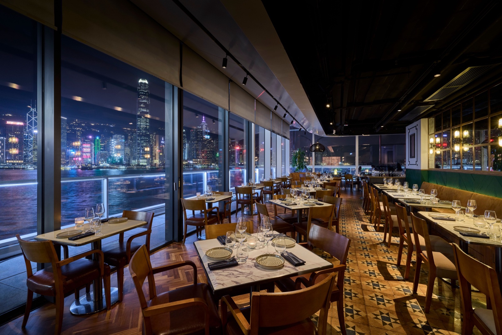 The Orient — main dining room with floor-to-ceiling glass framing Victoria Harbour at night